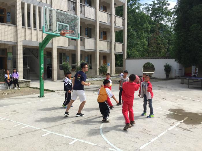 Having fun playing basketball together with children