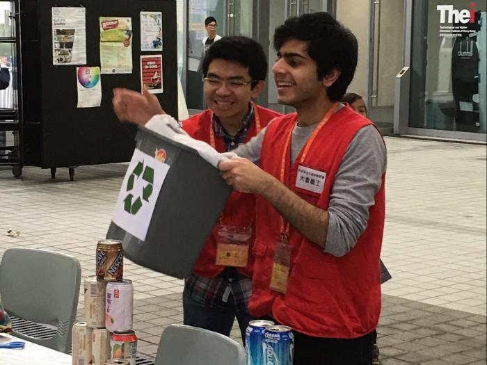 Volunteers holding games in the booth