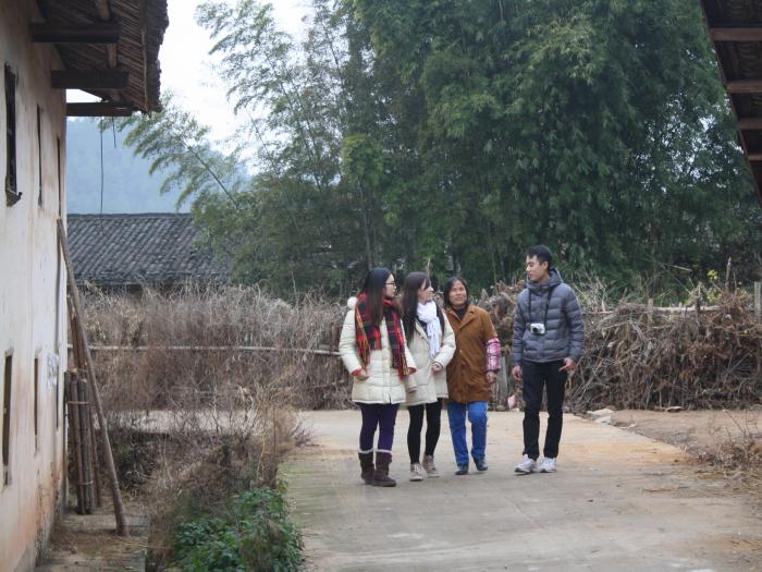 Volunteers talking happily with a family