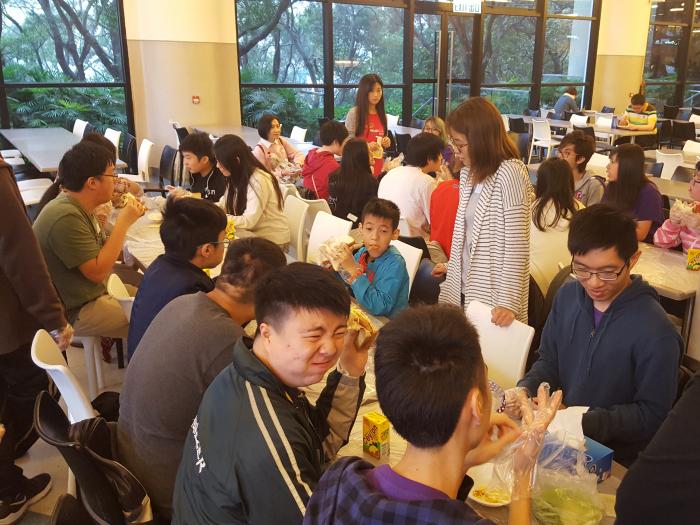 Participants enjoying sandwiches made together with the volunteers