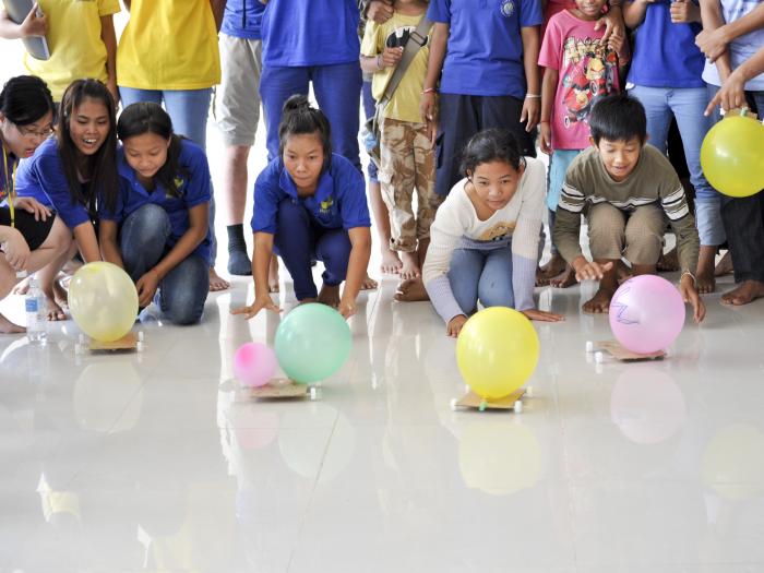 Children making their own balloon cars after learning the concept of air force