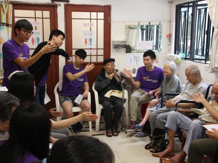 The elderly singing along with the volunteers with hand motions