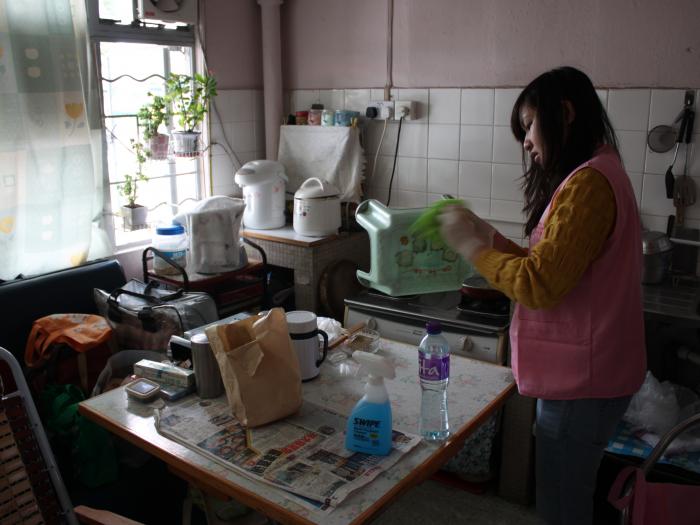 Volunteer cleaning the elder's home to welcome the Lunar New Year