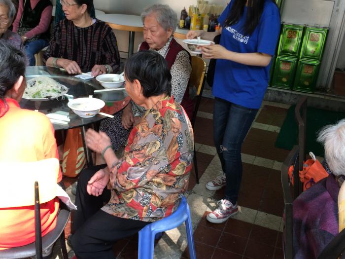 A group of volunteers serving the elders in a ccongee restaurant
