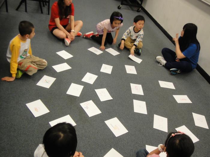 Volunteers playing a card game with the children to ask them identify the healthy food