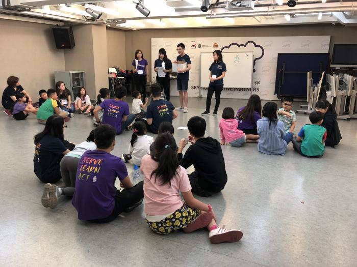 Volunteers introducing the children some writing tips