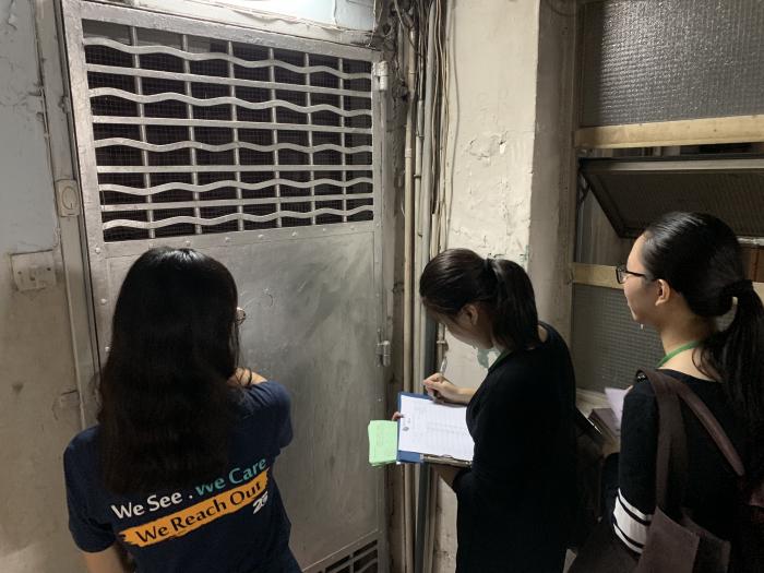 Volunteers approaching a household living in a subdivided housing unit