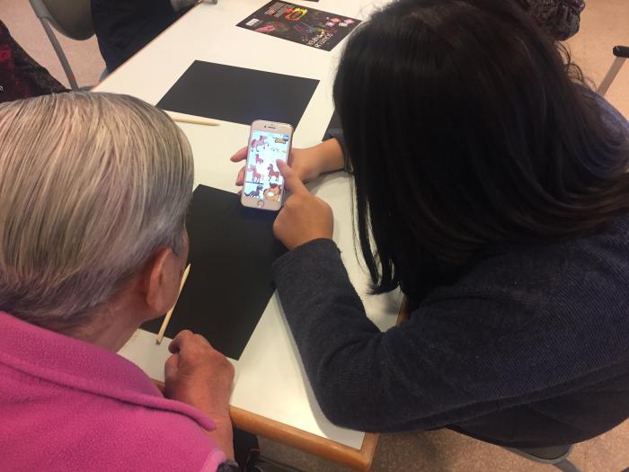 Volunteer showing a sample to the elderly
