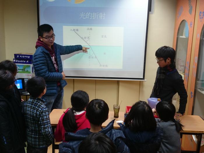 Volunteers explaining "refraction of light"