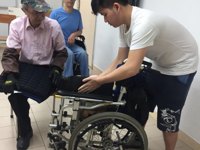 Volunteer learning how to use the wheelchair