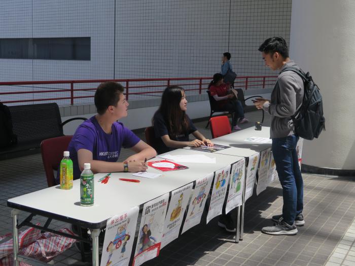 Volunteers promoting the event at the information booth
