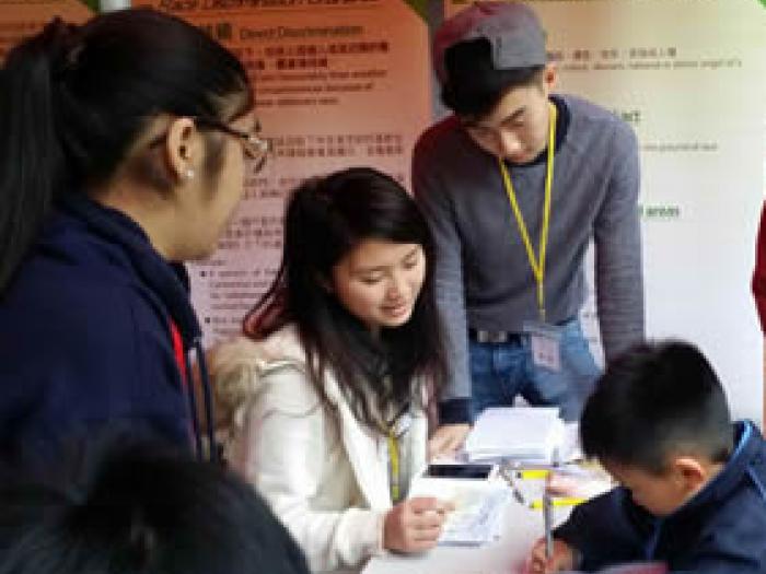 Volunteers hosting a booth game for the service recipients