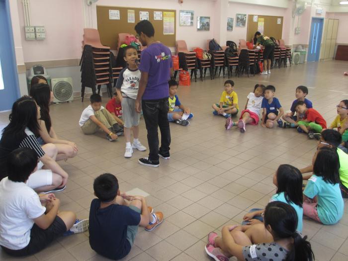 Volunteer inviting a child for sharing