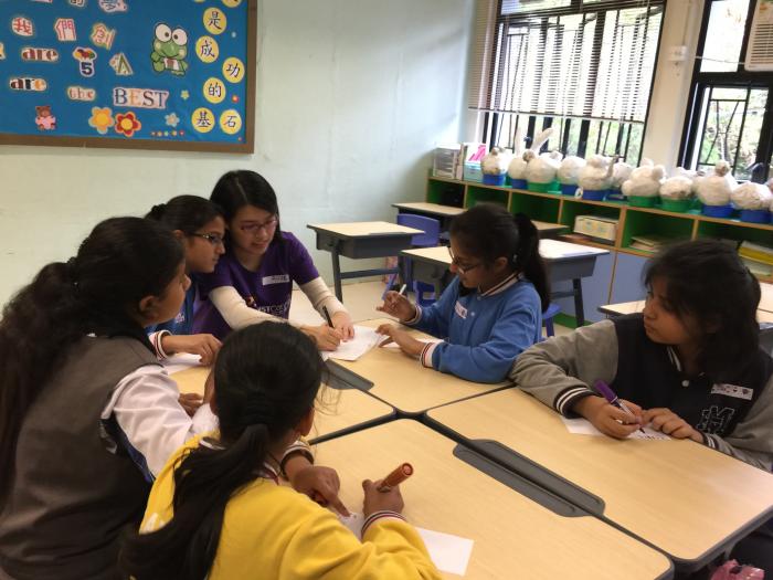 Volunteer demonstrating the task to the kids