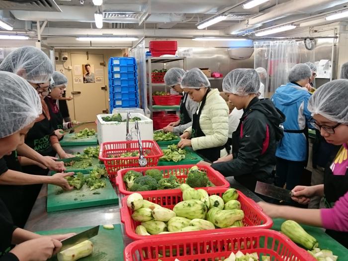 Our student volunteers chopping vegetables for the meal box