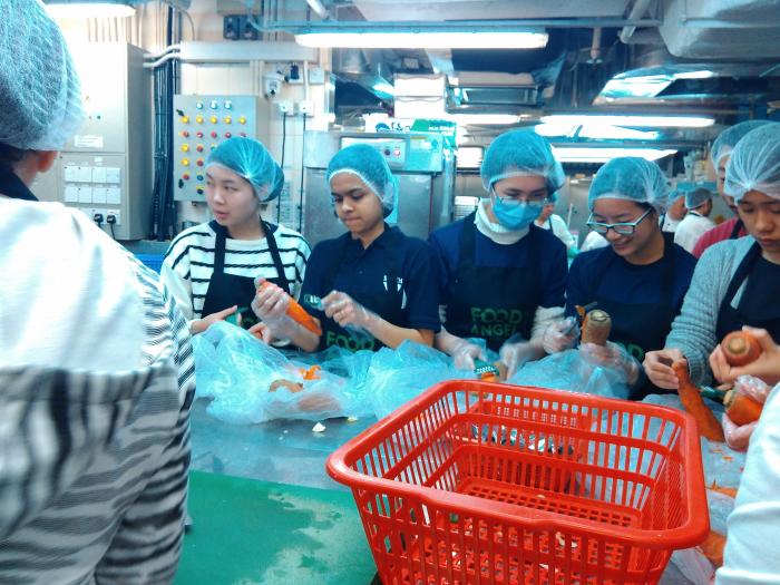 Volunteers preparing vegetables for the hot meals