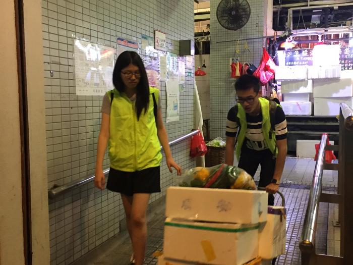 Volunteers transporting the unsold food to nearby needy elderly.
