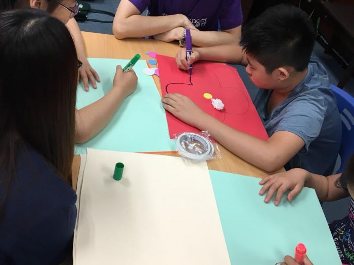 Volunteers drawing with recipients