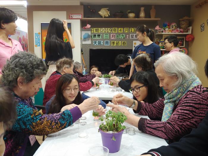Volunteers and elderly making their own anti-bug balm