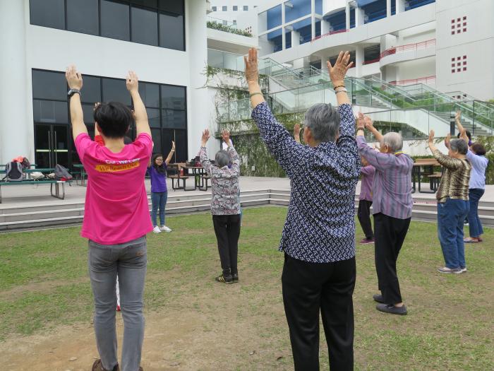 Volunteers leading the elderly to do exercise in HKUST