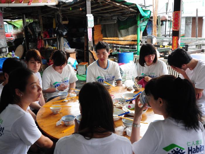 Students tasting local Tai O food during lunch.