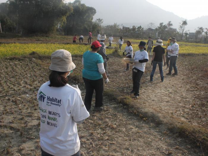 Forming a human chain to pass building materials