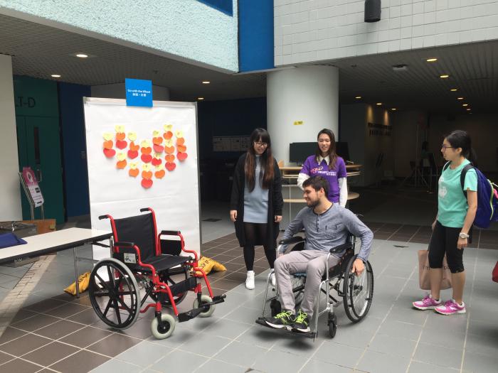 Fellow HKUST students trying out a wheelchair.