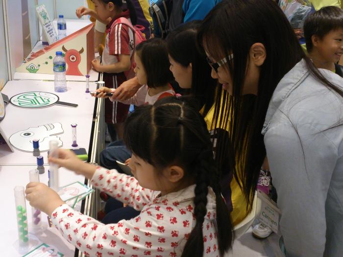 Volunteers playing in the booth with the kids
