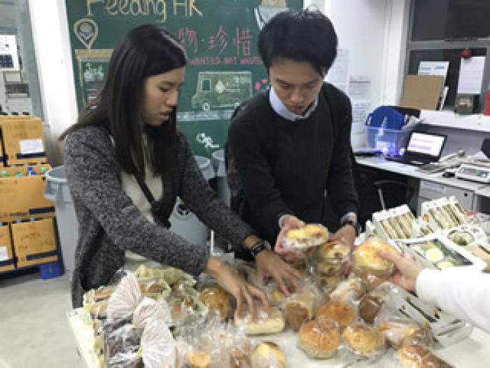 Volunteers help sort bread in warehouse of Feeding Hong Kong