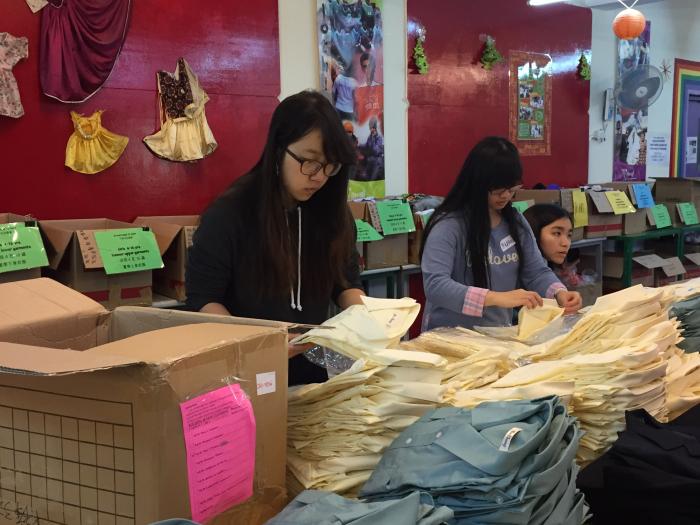 Volunteers re-packing the uniform according to different sizes