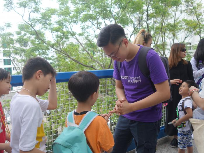 Volunteers playing different games with kids during a campus tour