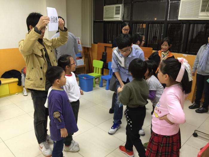 Volunteers playing Charades with the kids