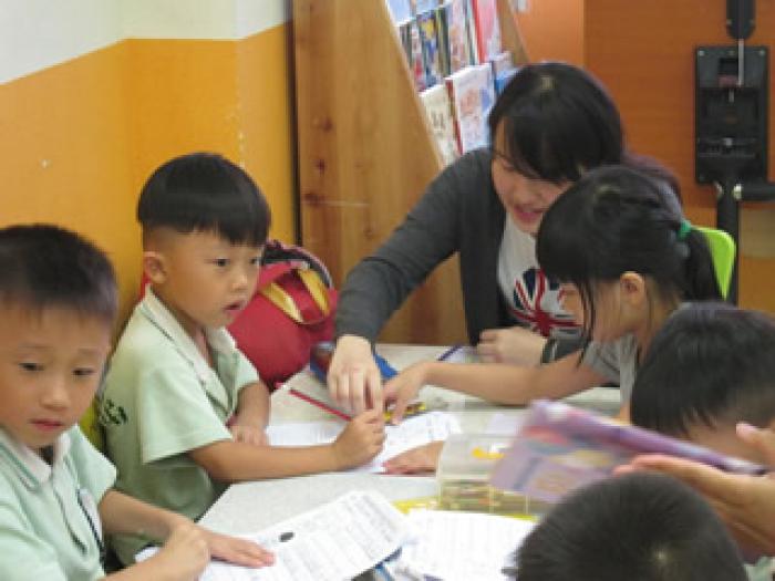 Volunteers guiding the kids to complete their homework