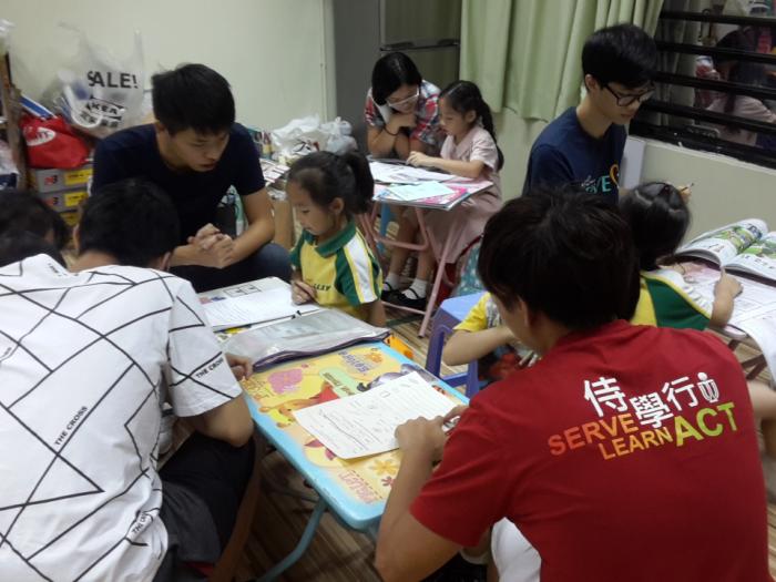 Vounteers helping childen with their homework