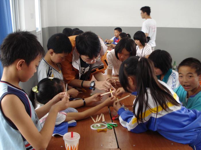 Student volunteers teaching the local children doing science experiments.