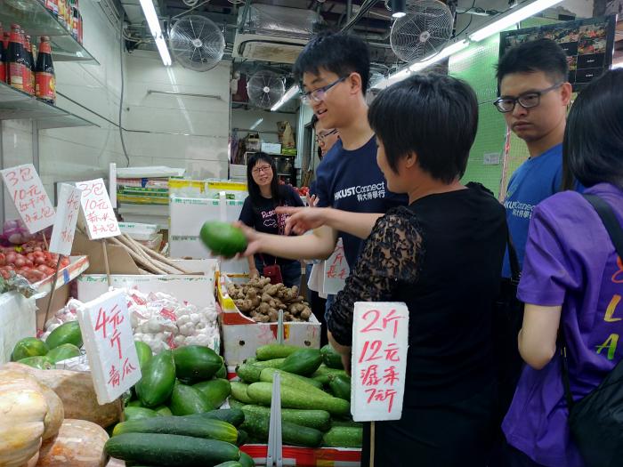 Volunteers purchasing ingredients in a wet market.