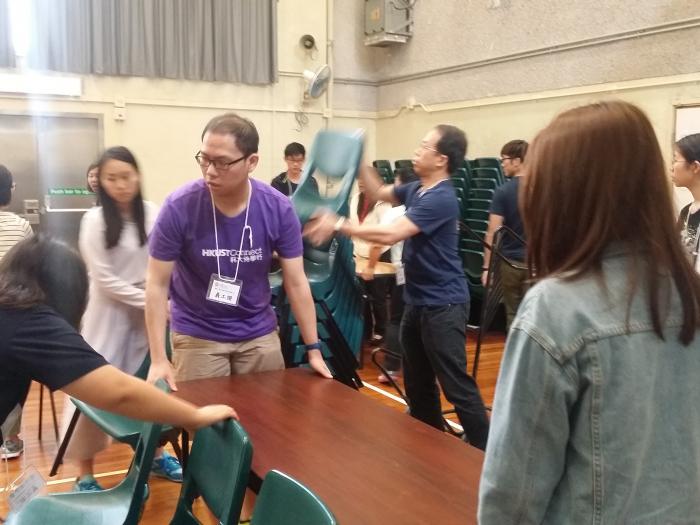 Volunteers preparing tables and chairs.