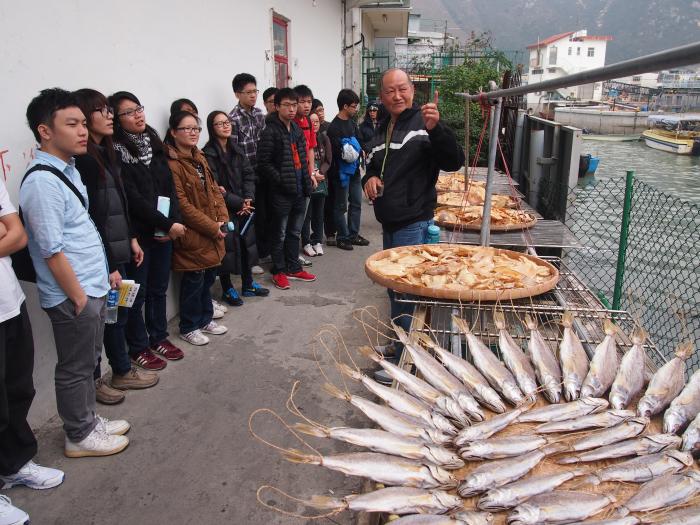Uncle Wing, a local Tai O resident, telling volunteers about the history of the community