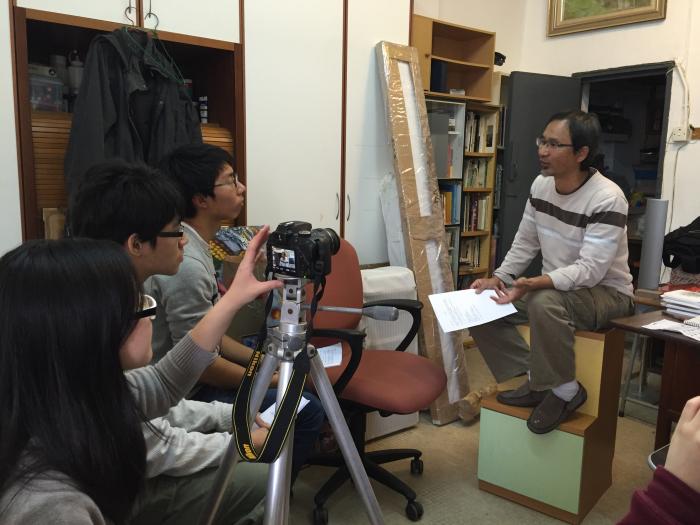 Volunteers interviewing a local painter, Mr Wong