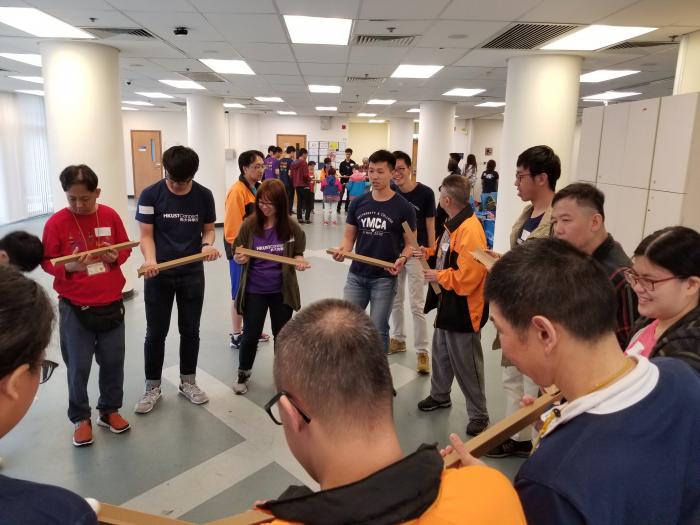 Volunteers playing a game with recipients