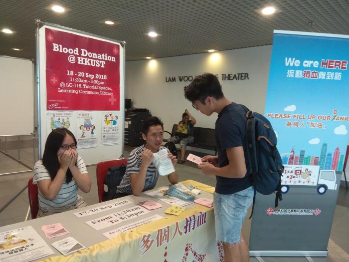 Volunteers set up promotion counter at the concourse