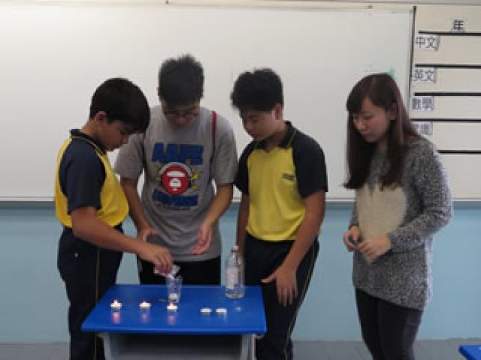 Volunteers assisting the children with science experiments