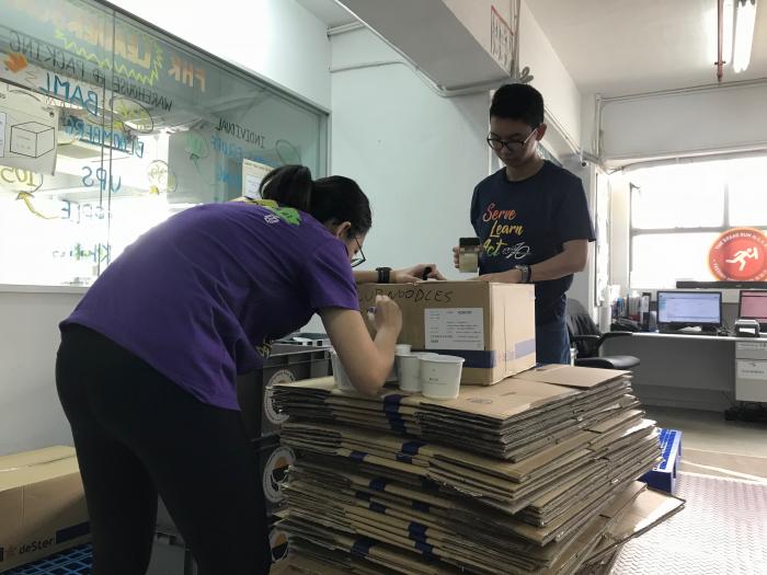 Volunteers checking the expiry dates of food donation 