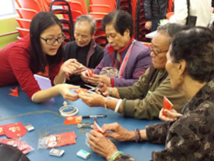 The elderlies making handicrafts with the help from volunteers