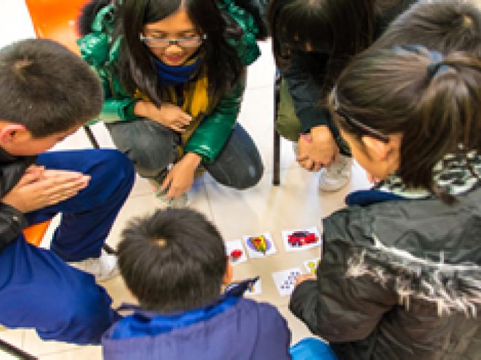 Volunteer playing smart games with local primary school students