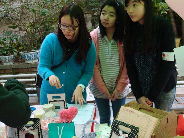The volunteers learning how to sell the cakes and candies