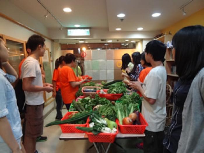 Vegetables and fruits being separated into baskets for the families