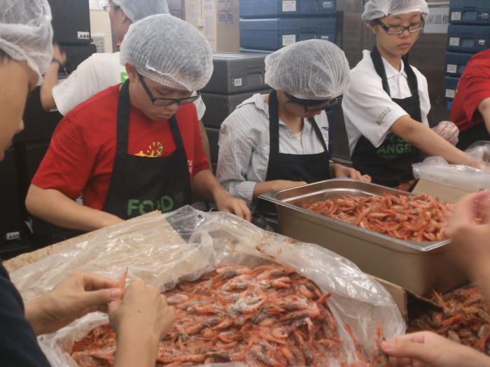 Our students preparing the shrimp for the meal box