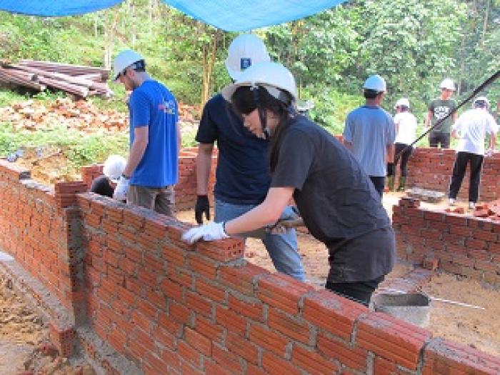 Laying bricks for the foundation of the house