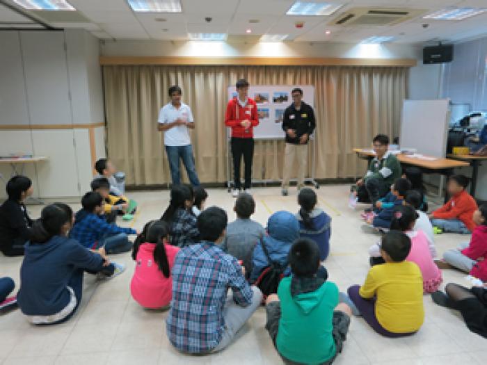 Volunteers greeting the children before the games start
